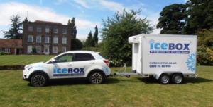 icebox-trailer-and-car-outside-a-house